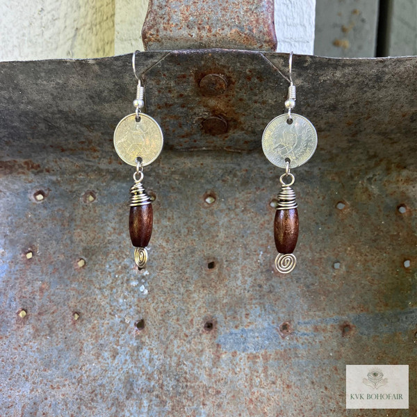 Handcrafted Guatemalan Coin Earrings hanging from an antique shovel