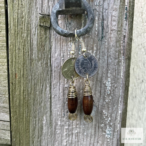 Handcrafted Guatemalan Coin Earrings handing from a wood door