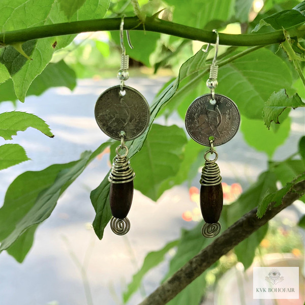 Handcrafted Guatemalan Coin Earrings hanging from a branch of a tree