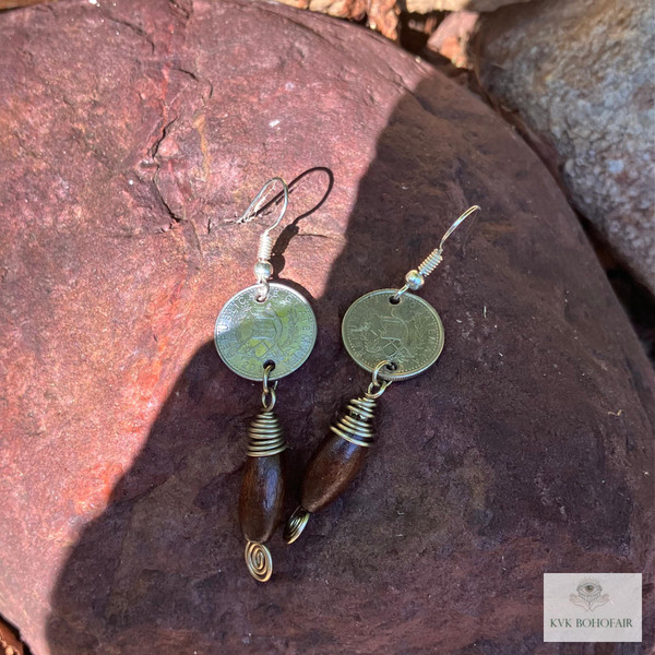 Handcrafted Guatemalan Coin Earrings sitting on a red rock