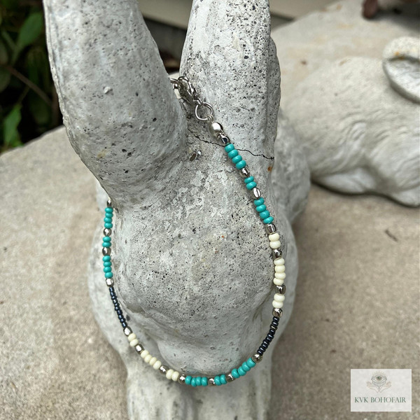 Handcrafted Boho Anklet with Turquoise & Silver Beads on a cement bunny