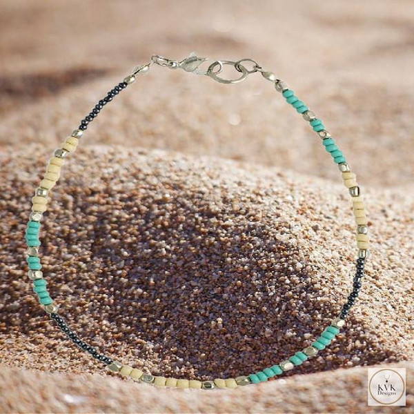 Handcrafted Boho Anklet with Turquoise & Silver Beads in sand