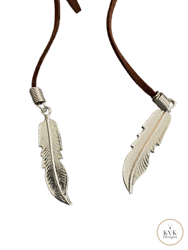 Boho Chic: Brown Suede Lariat Feather Necklace showing silver feathers on white background