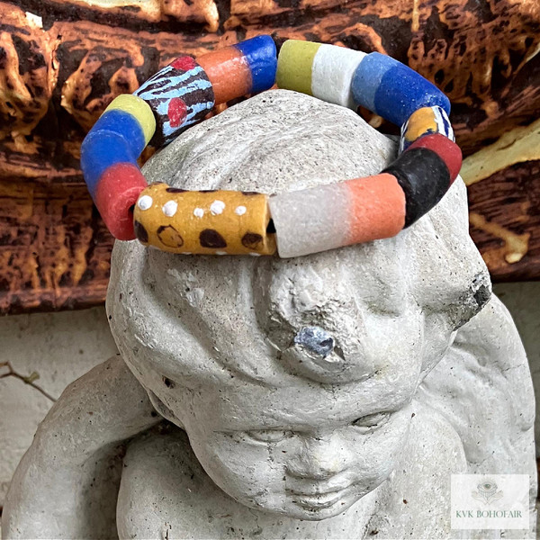 Handcrafted African Trade Bead Bracelet on a stone cherub head