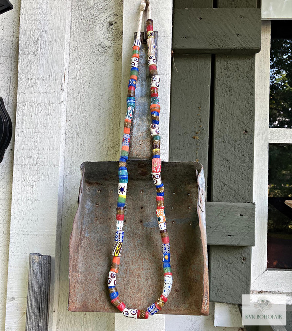 Long African Trade Bead Necklace hanging from an antique shovel