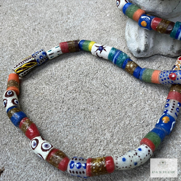 Long African Trade Bead Necklace laying on cement