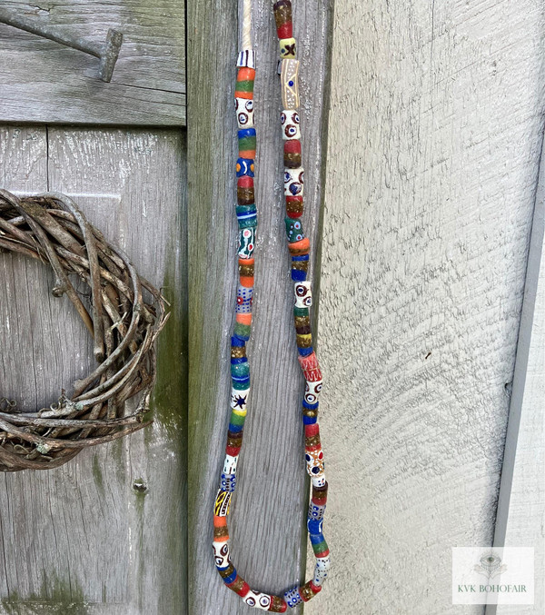 Long African Trade Bead Necklace hanging from a vintage door