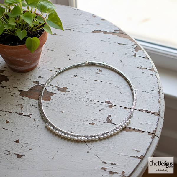 Freshwater Pearl and Green Silk Woven Choker sitting on a white distressed table