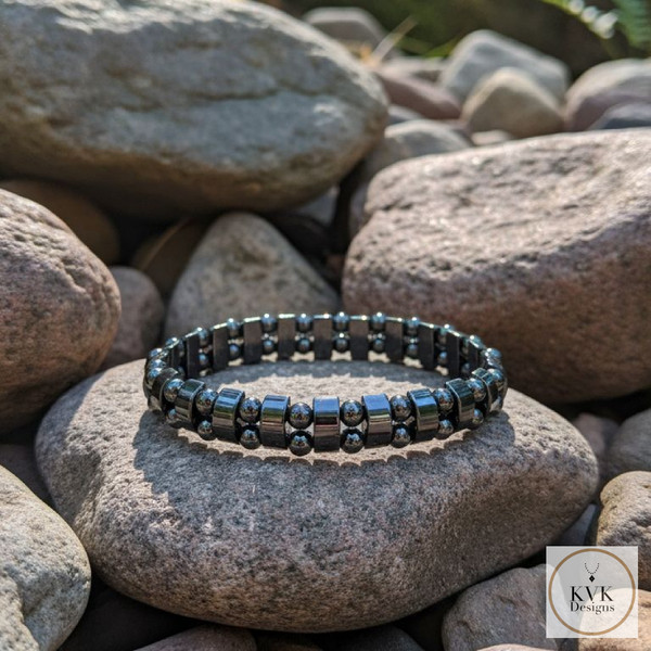 Women's Magnetic Hematite Black Pearl Bracelet sitting on rocks outside