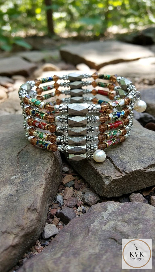 Cloisonne Magnetic Hematite Wrap Bracelet  21"l sitting on rocks outside