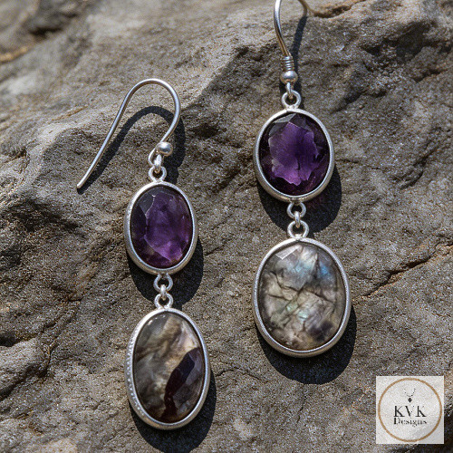 Freeform Amethyst and Labradorite Earrings laying on rocks outside