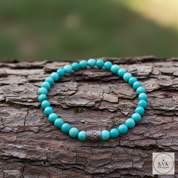 Blue Magnesite Bead Bracelet sitting on a log outside