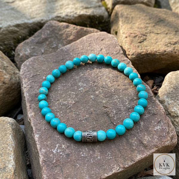 Blue Magnesite Bead Bracelet sitting on rocks outside