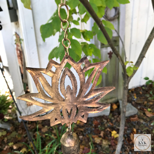 Lotus Flower Chime, Wind Chimes hanging on a tree branch with leaves