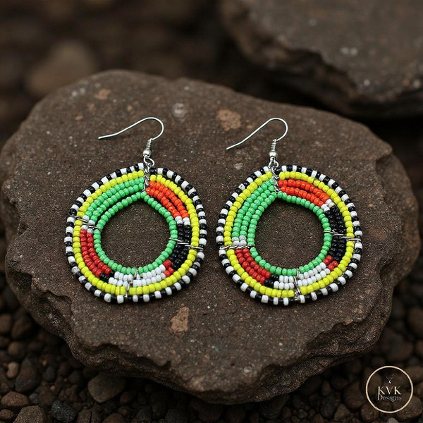 Colorful Round Maasai Beaded Earrings sitting on a rock