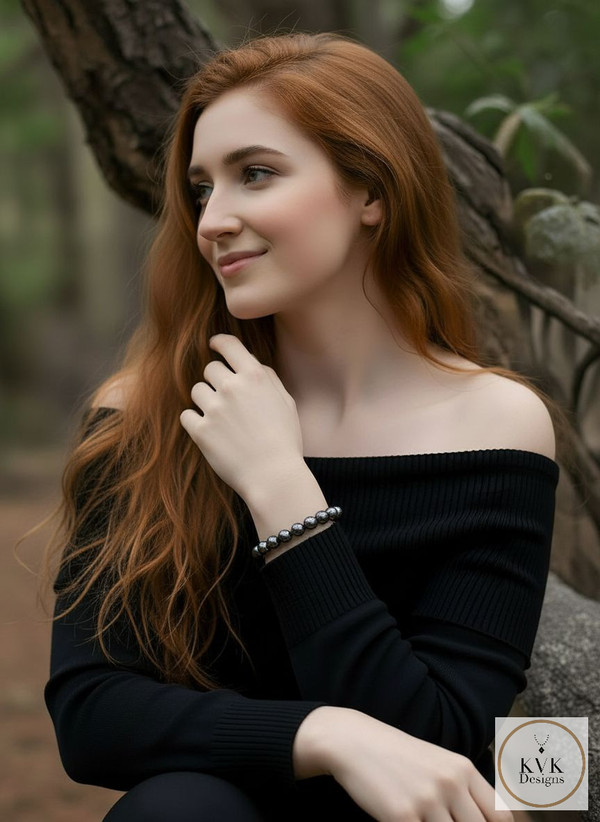8mm Hematite Bead Stretch Bracelet worn on model wearing black off the shoulder sweater