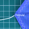 Close up of the 1.7 oz parachute from Top Flight Recovery showing stitching, a shroud line and the hem of the product.