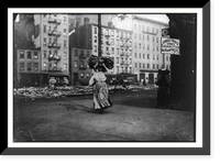 Historic Framed Print, Woman carrying heavy bundle of clothing to be finished at home. Near Astor Place, N.Y. Location: New York, New York (State),  17-7/8" x 21-7/8"
