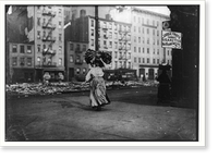Historic Framed Print, Woman carrying heavy bundle of clothing to be finished at home. Near Astor Place, N.Y. Location: New York, New York (State),  17-7/8" x 21-7/8"