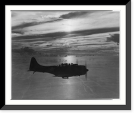 Douglas dive bomber returns to base after patrol flight as sun sets across the Pacific, Historic Print