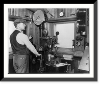 Bridge tender Edward Lundahl posed with the gongs, phone, and other signal alarms and controls in the guard building on the Link Bridge, Chicago, Historic Reproduction