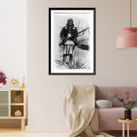 Historic Framed Print, [Scene in Geronimo's camp...before surrender to General Crook, March 27, 1886: Geronimo, full-length portrait standing, facing left, rifle at port],  17-7/8" x 21-7/8"