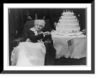 Mary Mother" (Harris) Jones, 1830-1930, half-length portrait, seated, facing left, about to cut a large birthday cake on her hundredth birthday anniversary", Vintage Print