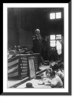 One way to keep the children out of the mill. Mrs. D.E. Hudson, South Boston, Va. Her children are seated around her. In the chairs are some of her boarders. Children are well-kept. The home showed