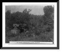 Mary Faust's cabin, Anderson County, Tennessee. Man and two women standing outside log cabin, which is surrounded by a heavy growth of vegetation, Vintage Wall Art