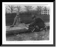 Historic Framed Print, Ricardo and Angelica Pueyrredon putting on ice skates at Reflecting Pool,  17-7/8" x 21-7/8"