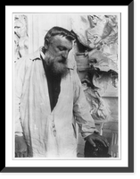 Auguste Rodin, 1840-1917, three quarters length portrait, face looking down, facing right, hand on sculpture. Taken in Meudon, France, about 1906, Vintage Wall Art