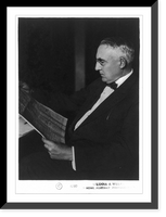 Historic Framed Print, [Warren Gamaliel Harding, three-quarters length portrait, seated, looking at newspaper, facing left],  17-7/8" x 21-7/8"