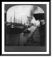 Historic Framed Print, A passing tug showing unloaders at work on both sides of harbor, Conneaut, Ohio,  17-7/8" x 21-7/8"