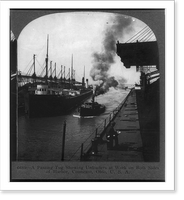 Historic Framed Print, A passing tug showing unloaders at work on both sides of harbor, Conneaut, Ohio,  17-7/8" x 21-7/8"