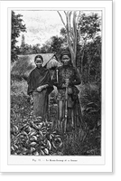 Historic Framed Print, [Natives of Indochina]: man and woman in front of thatched hut,  17-7/8" x 21-7/8"