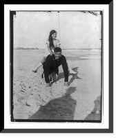 Jack Dempsey at his training camp, June 1921: kneeling on beach, with small girl piggyback, Antique Poster
