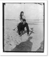 Jack Dempsey at his training camp, June 1921: kneeling on beach, with small girl piggyback, Antique Poster