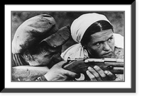 Soviet guerrilla activity in Russia, WWII: Woman beside man sighting rifle, Vintage Print