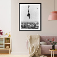 Photographer with camera suspended from hook of a (crane?) high in the air, Vintage Print