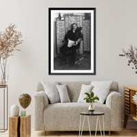 David E. George, full-length portrait, seated, facing left, holding newspaper Classic, Vintage Poster