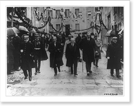 Raymond Poincar&eacute;, surrounded by civil, municipal, and military authorities walking through the streets of Sampigny, on his way to make his recent speech on the reparations issue Classic Wa