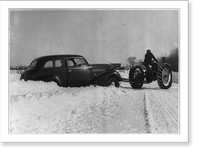 Warren Butters, farmer of Exeter, Maine, gets a lift out of a snow bank from the tractor Classic, Historic Print