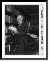 Oscar Solomon Straus, 1850-1926; three-quarters length, standing beside large bookcase, facing left; holding book Classic, Historic Reproduction