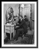 John Drew, 1853-1927, full length, seated at dressing table, facing left; in Empire Theatre, Historic Reproduction