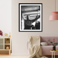 John Daniel Rust, 1892-1954, half-length portrait, standing, facing left; operating mahcine. Inventor of the cotton picker, Antique Poster