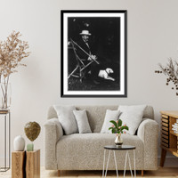 Historic Framed Print, [Alton Brooks Parker, 1852-1926, full length portrait, seated in rustic chair, facing right; with dog on lawn; wearing straw hat],  17-7/8" x 21-7/8"