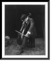 Historic Framed Print, [Sir Charles Chaplin, 1889-1977, full length portrait, seated, facing right; playing cello],  17-7/8" x 21-7/8"
