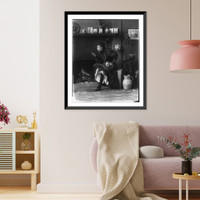 Historic Framed Print, [Frances Benjamin Johnston, full-length portrait, seated in front of fireplace, facing left, holding cigarette in one hand and a beer stein in the other, in her Washington, D.C. studio],  17-7/8" x 21-7/8"