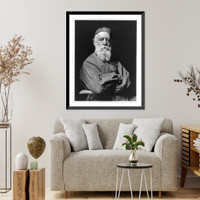 Half-length portrait of bearded man wearing artist's smock and cap and holding a sculpting tool, facing front, Vintage Wall Art