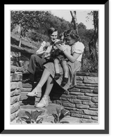 Manuhin at home. Alma, Calif. - Yehudi Menuhin, his wife and son, Krov seated on rock wall near the pool at the estate, Historic Print